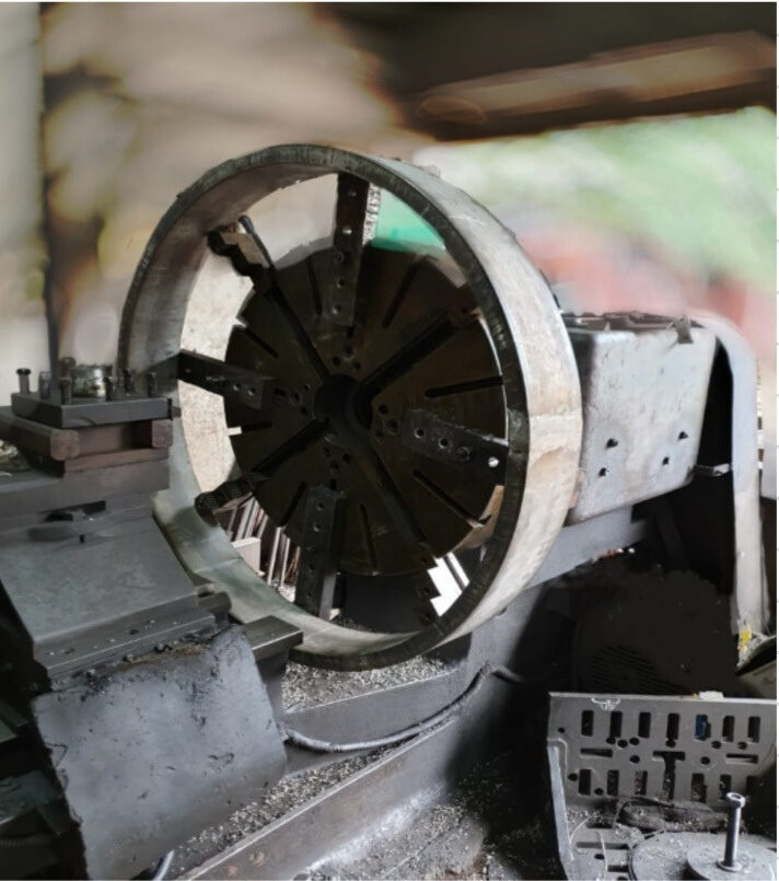 Very large steel ring mounted on faceplate chuck